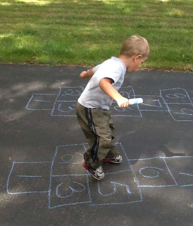 Son playing hopscotch as part of physical therapy @meredithspidel