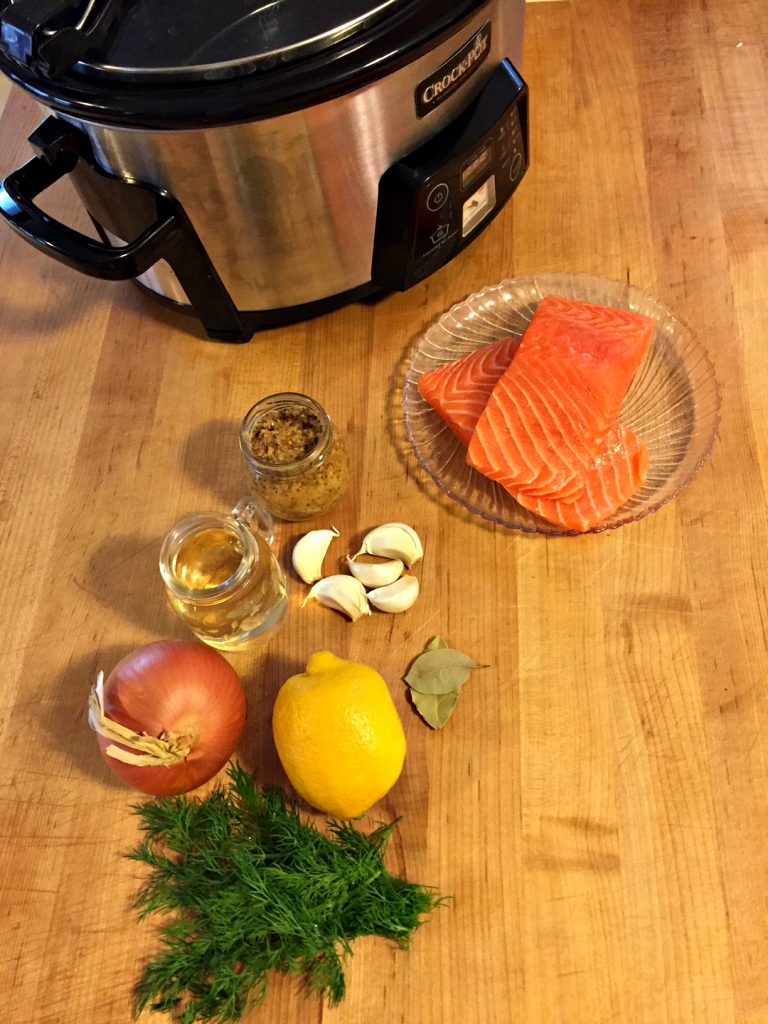 Looking for a quick, healthy crockpot meal for your family? This slow cooker poached salmon recipe is simple way to serve a delicious family dinner--prep time under 30 minutes! Plus, check this trick for getting your kids to fall in love with salmon--it's a win!