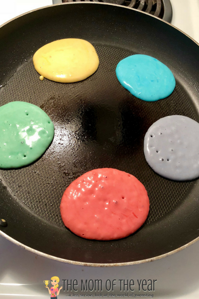 Looking for a perfect, easy St. Patrick's Day treat? These End of the Rainbow St. Patrick's Day Pancakes are a HUGE hit with the whole family--and so easy and fun! The perfect breakfast treat!