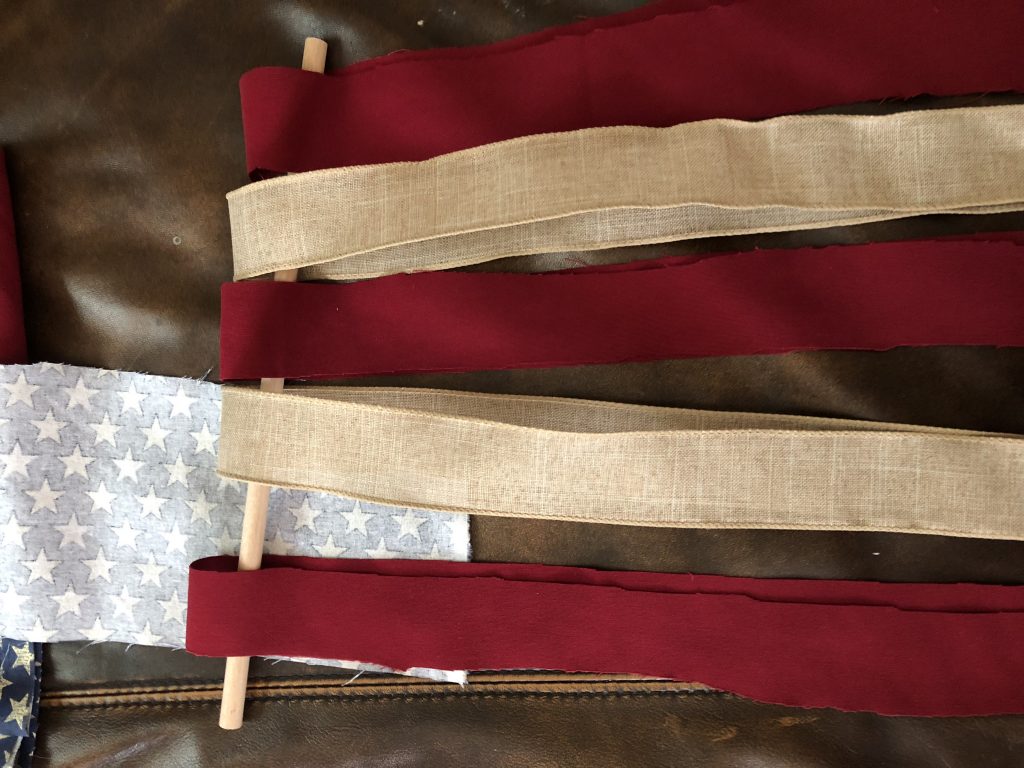 This DIY ribbon flag is the perfect July 4th decoration for your rustic, antiqued home decor theme! IT's SO EASY AND CHEAP to make, plus only takes 30 minutes! Make sure to grab the pro tip in the post too!
